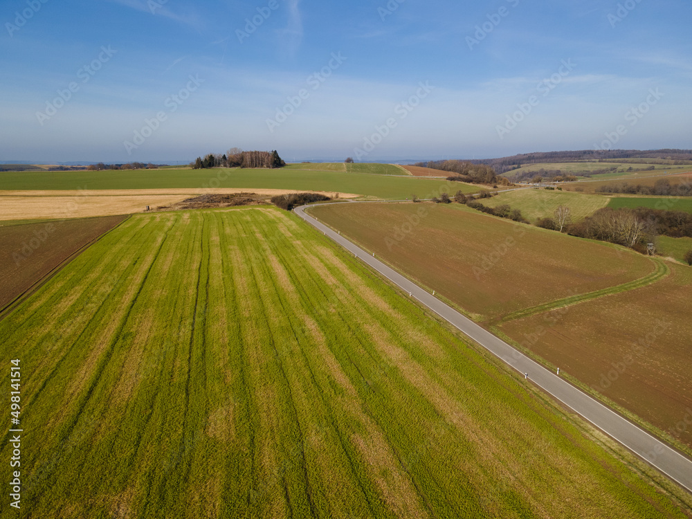 Aerial view of agricultural fields in the landscape with a blue sky on a sunny day in spring