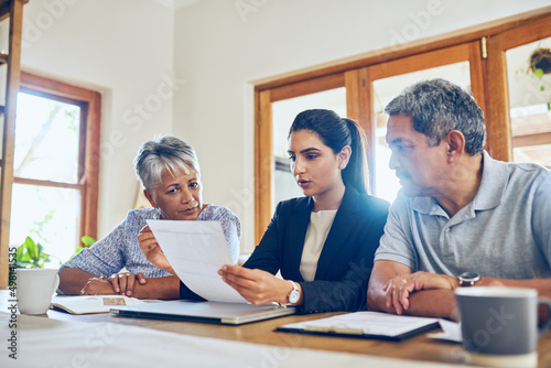 This policy would suit your needs best. Shot of a mature couple getting advice from their financial consultant at home.