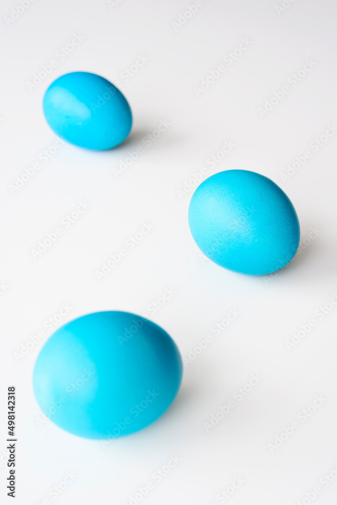 Blue easter eggs, lying on a white background, with copy space. Easter concept.