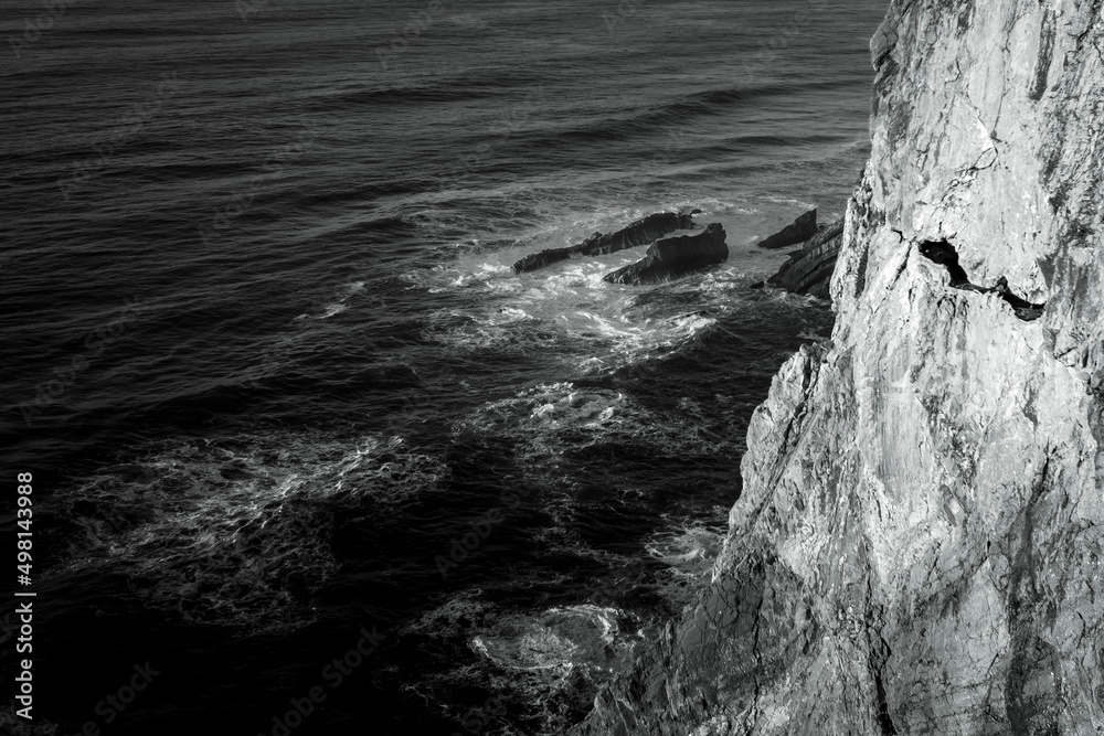 View of the cliffs in Atlantic Ocean, Portugal. Black and white photo. View of the cliffs in Atlantic Ocean, Portugal. Black and white photo.