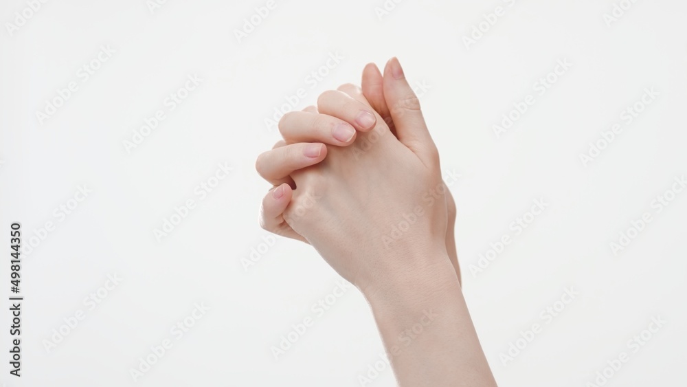 Interlocked female hands on white background, close-up shot | Hand care concept