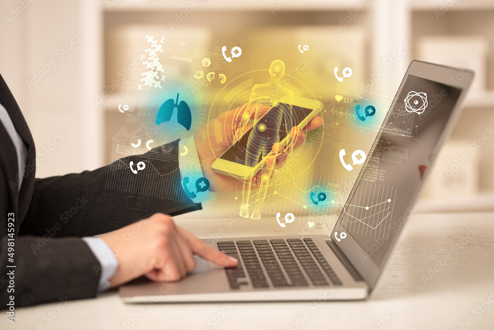 Doctor working on laptop with healthcare concept Doctor working on laptop with healthcare concept