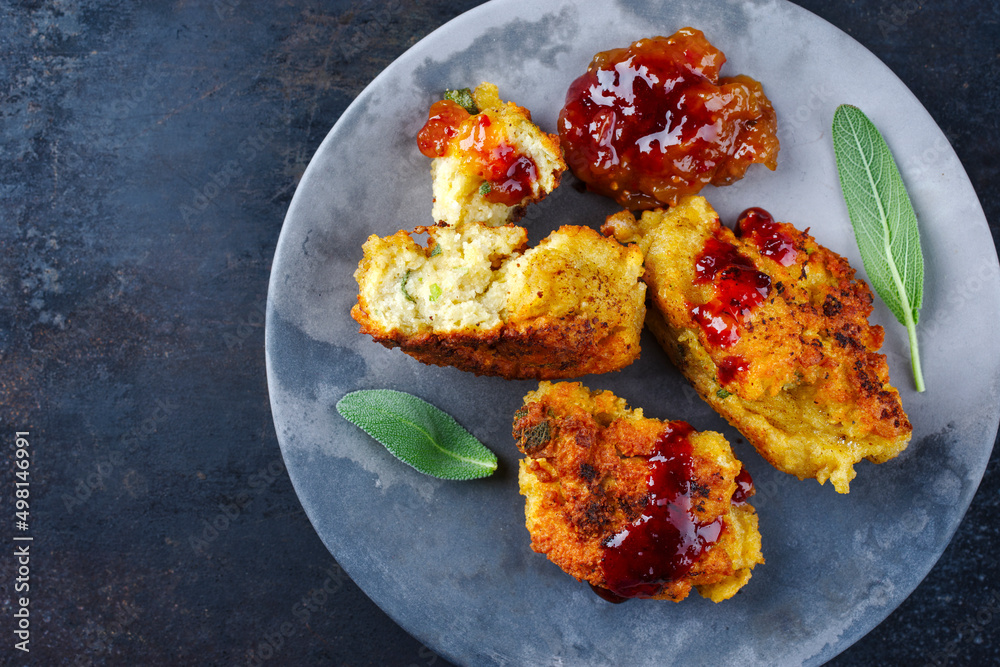 Traditional deepfried gnocchi with spicy sauce served as top view on a
