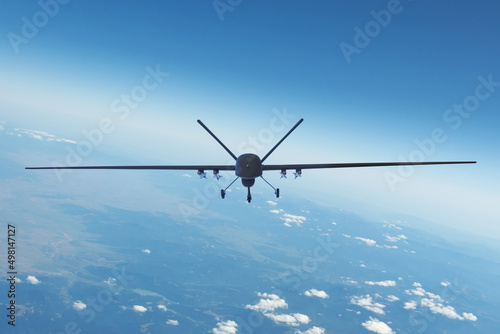 Air Force unmanned aerial vehicle with military equipment flying near base, straight front view.