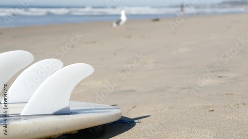 Canvas Print Surfboard for surfing lying on beach sand, California coast, USA