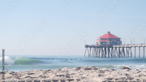 Retro huntington pier, surfing in ocean waves and sandy beach, California coast near Los Angeles, USA. American diner, sea water, beachfront boardwalk, summer vacations. Seamless looped cinemagraph. photo