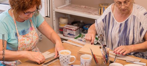 Women in art workshop making decoupage boxes