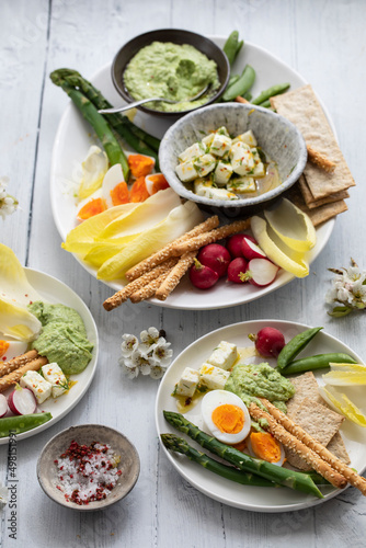 Easter sharing platter with eggs, asparagus, crunchy vegetables and feta