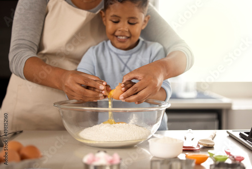 A lesson in tenderness. Cropped shot of an adorable little boy baking with his mom at home.