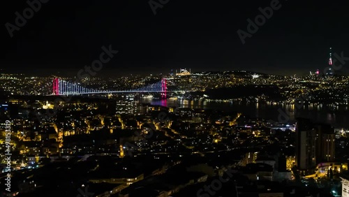 Aerial Night view of Istanbul, Bosphorus with illuminated Bridges. Cinematic panorama. Smooth flowing, heavy traffic during rush hour on Bosporus Bridge. Hundreds of thousands of vehicles use Istanbul photo