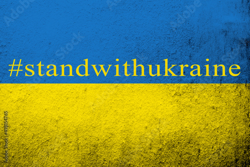 hashtag standwithukraine.Dirty Ukraine flag with anti war text. Grunge background photo