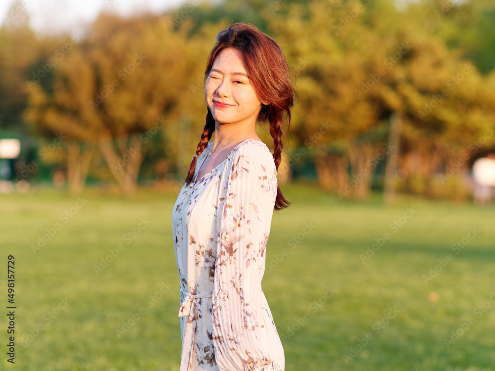Portrait of elegant Chinese girl in dress enjoy carefree time in forest park in sunny day. Outdoor fashion portrait of glamour young Chinese cheerful stylish woman. Portrait of elegant Chinese girl in dress enjoy carefree time in forest park in sunny day. Outdoor fashion portrait of glamour young Chinese cheerful stylish woman.