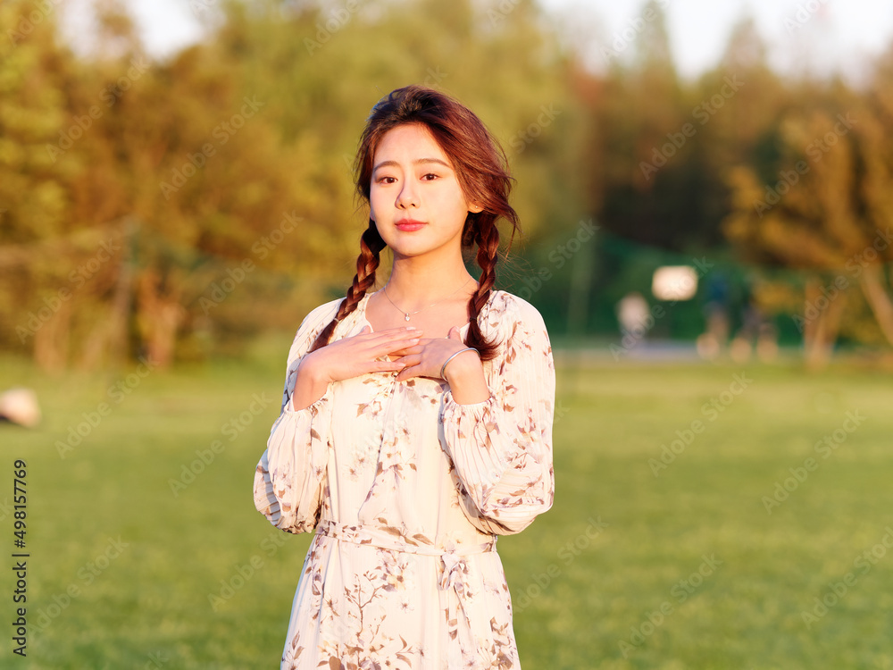 Portrait of elegant Chinese girl in dress enjoy carefree time in forest park in sunny day. Outdoor fashion portrait of glamour young Chinese cheerful stylish woman. Portrait of elegant Chinese girl in dress enjoy carefree time in forest park in sunny day. Outdoor fashion portrait of glamour young Chinese cheerful stylish woman.