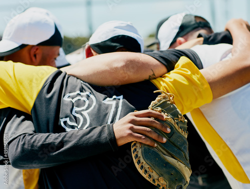 Unity - every team needs it. Cropped shot of a team of unrecognizable baseball players standing together in a huddle on the field. photo