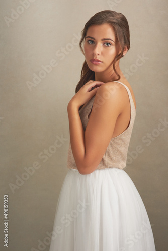 Darling, youre different. Studio shot of an attractive young woman posing against a brown background.