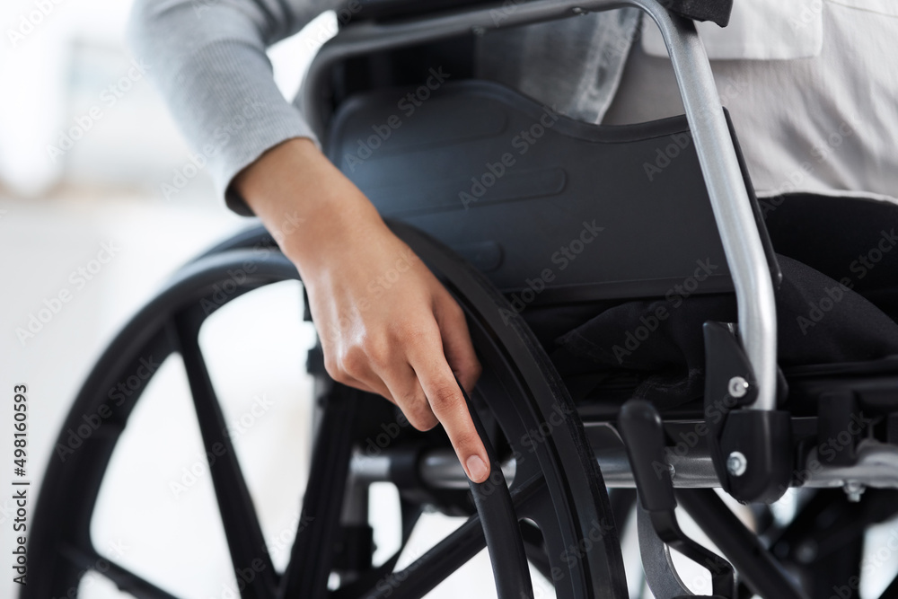 Shes ready to get moving. Cropped shot of an unrecognizable businesswoman sitting in a wheelchair in the office. Shes ready to get moving. Cropped shot of an unrecognizable businesswoman sitting in a wheelchair in the office.