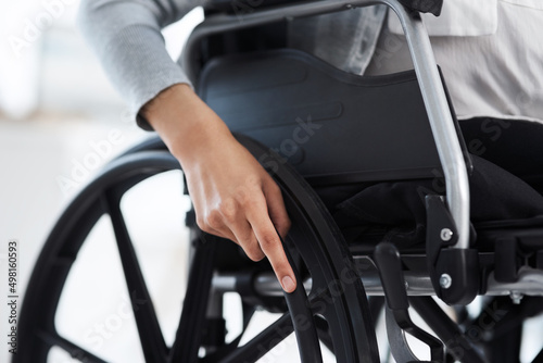 Shes ready to get moving. Cropped shot of an unrecognizable businesswoman sitting in a wheelchair in the office.