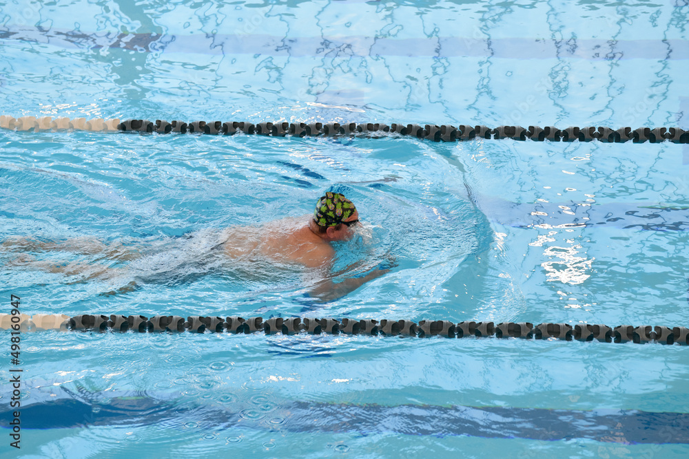 Adult male swimmer with funny cap