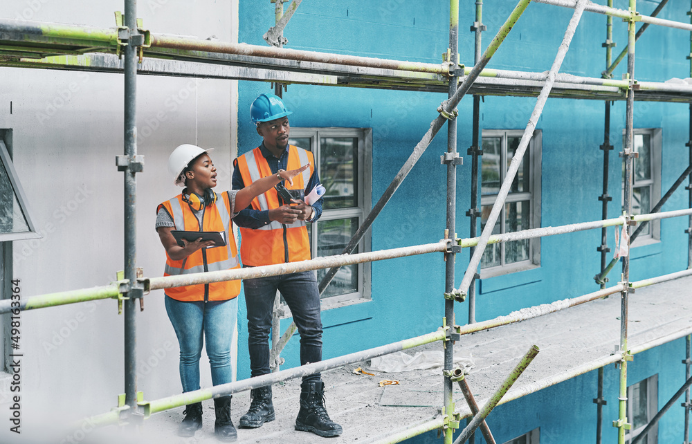 Shaping the future of construction with the help of smart apps. Shot of a young man and woman using a digital tablet while working at a construction site.