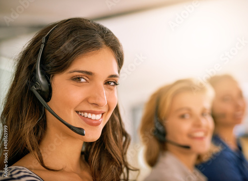 Service with a smile. Cropped portrait of a young woman working alongside her colleagues in a call center.