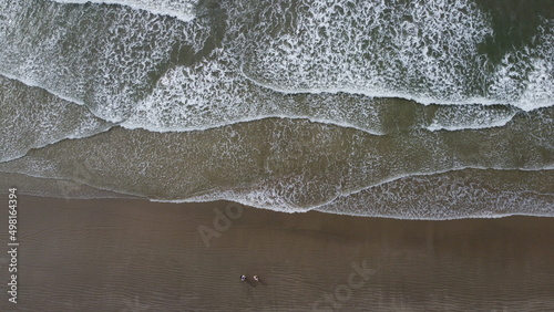 Aerial photo with drone on the beach showing the waves of the sea.