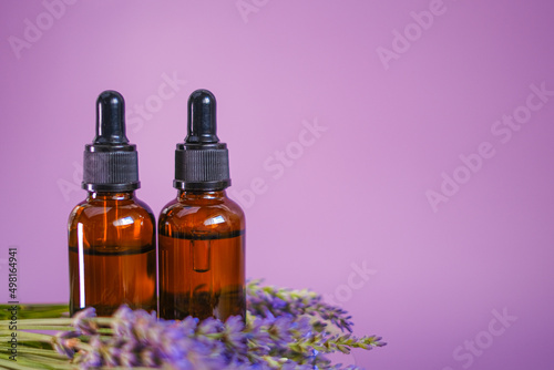 Lavender oil.Aroma of lavender.Essence with lavender scent. Aromatherapy and massage.Brown glass bottles of essential oil and lavender flowers.