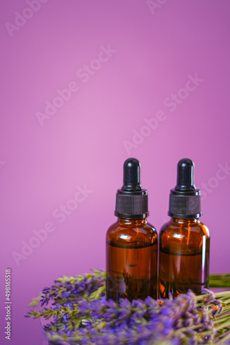 Lavender oil.Aroma of lavender.Essence with lavender scent. Brown glass bottles of essential oil and lavender flowers.