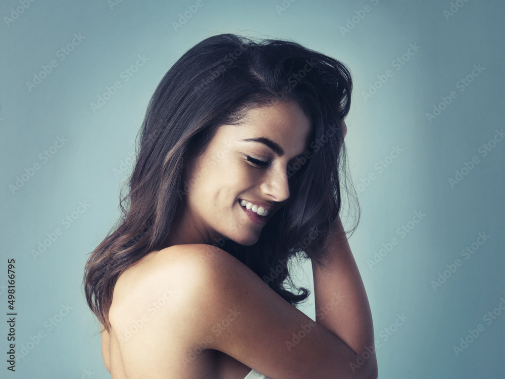 Her smile can light up the darkest room. Cropped shot of a beautiful young woman posing in the studio.