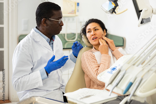 Woman with toothache sitting in chair at dentist appointment