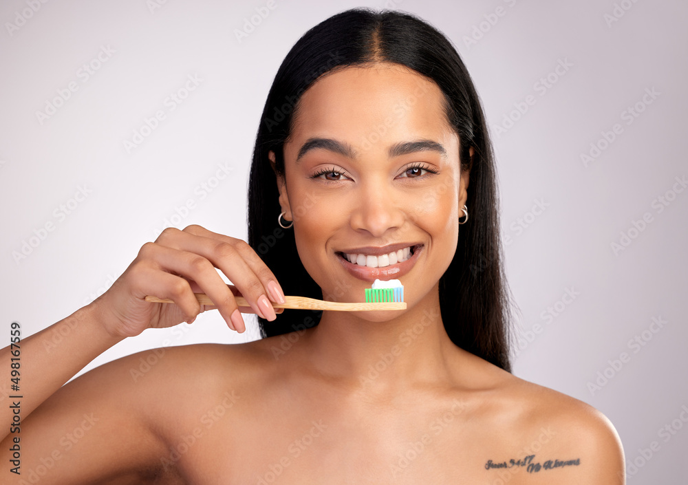 Keeping your teeth nice and white. Studio portrait of an attractive young woman brushing her teeth against a pink background. Keeping your teeth nice and white. Studio portrait of an attractive young woman brushing her teeth against a pink background.