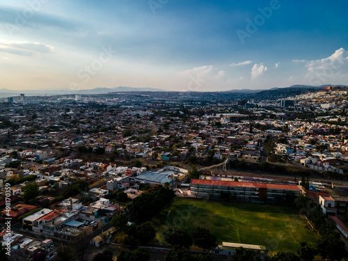 Fototapeta Naklejka Na Ścianę i Meble -  hermosa vista aerea de dron de el centro de queretaro mexico, drone clouds, city, colonial city, green grass, football filed