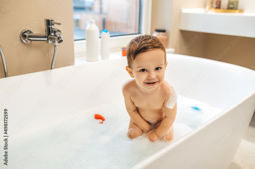 Cheerful child posing for the camera in the bathroom Cheerful child posing for the camera in the bathroom