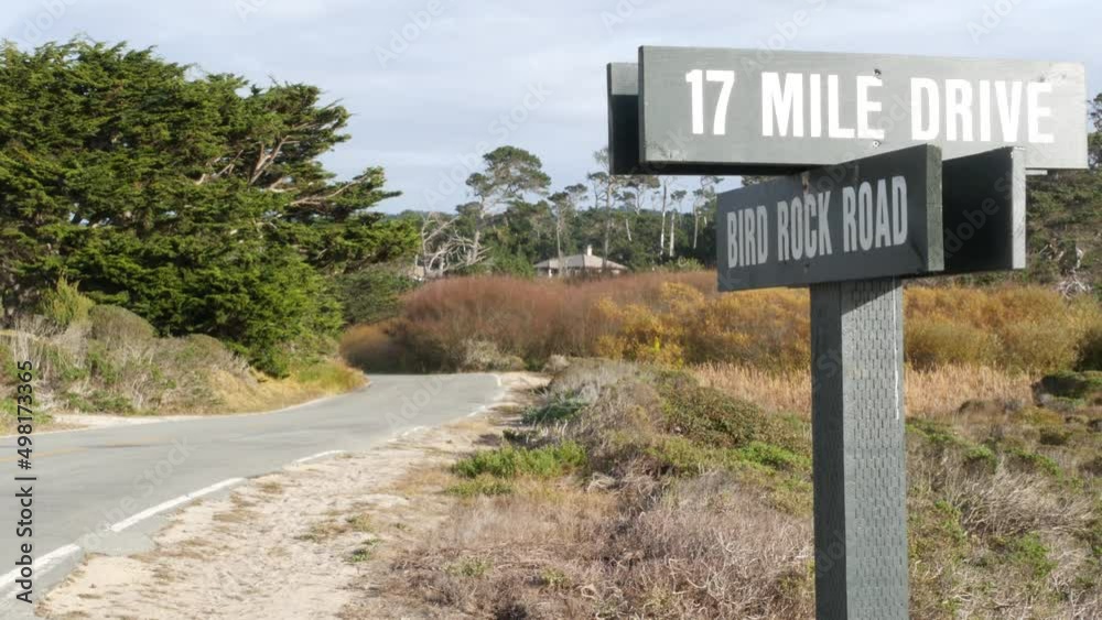 Scenic 17-mile drive wooden road sign, Monterey peninsula, Big Sur, California, USA. Coastal roadtrip, cypress forest. Pacific coast highway tourist route. Hitchhiking trip, ecotourism on vacations. Scenic 17-mile drive wooden road sign, Monterey peninsula, Big Sur, California, USA. Coastal roadtrip, cypress forest. Pacific coast highway tourist route. Hitchhiking trip, ecotourism on vacations.