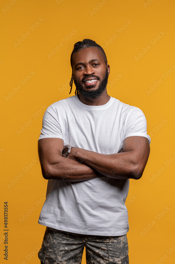 Smiling handsome African American male standing indoors Smiling handsome African American male standing indoors