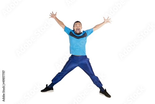 Happy man jump on studio while wears sportswear
