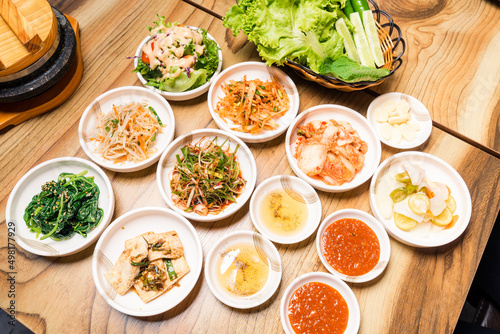 Spicy Kimchi group. Korean pickle or Pickled radish vegetables and seasoning on bowl on wood table background, Japanese food