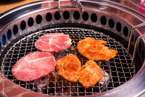 Korean beef barbecue on hot coals. Grilling meat pork Korean BBQ traditional style on stove serve in restaurant, Japanese food