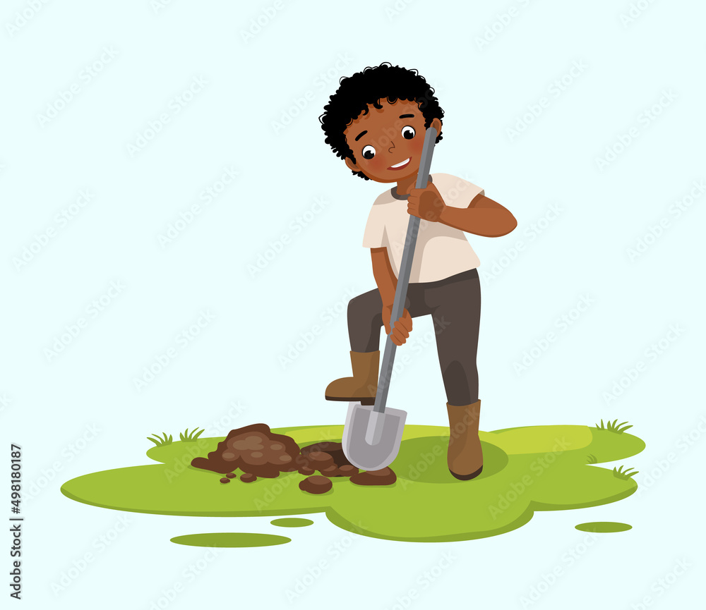 Cute little African boy digging hole on the ground with shovel in the garden