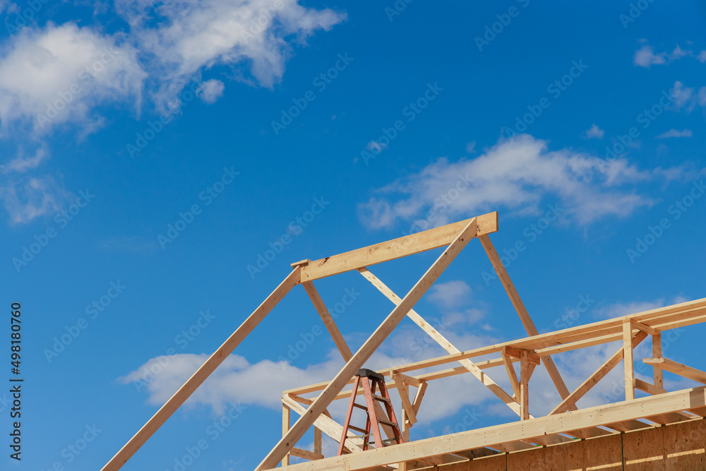 Wooden roof truss framing under construction in new home Wooden roof truss framing under construction in new home