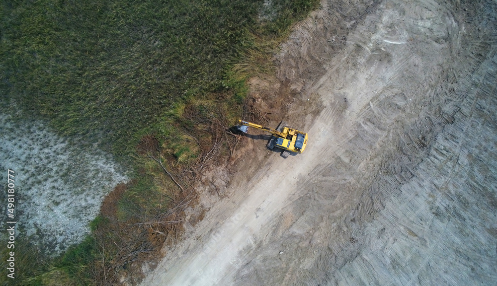 Aerial view Crawler excavator truck under digging work on demolition construction site.