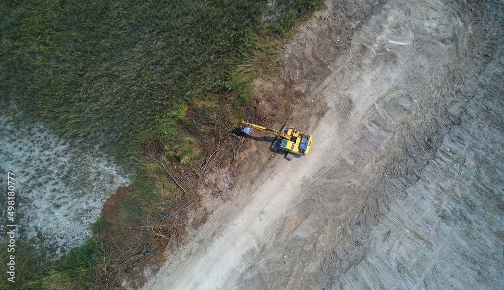 Aerial view Crawler excavator truck under digging work on demolition construction site. Aerial view Crawler excavator truck under digging work on demolition construction site.