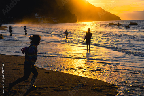 Enjoying summer at the beach of Puerto Galera, Philippines at sunset photo