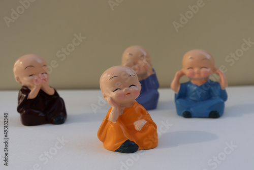 Selective focus on laughing Buddha with isolate background. Cute little colorful laughing Buddha. Small colorful Toys photo