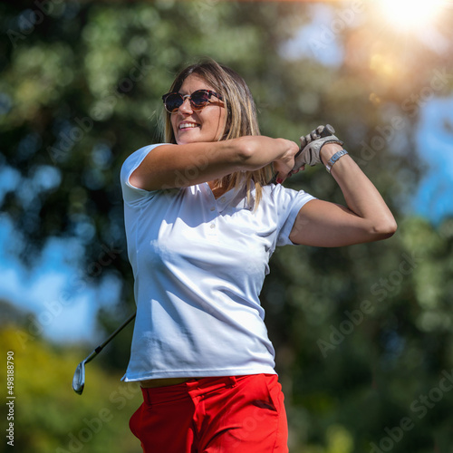Female golfer, golfing on a beautiful summer day