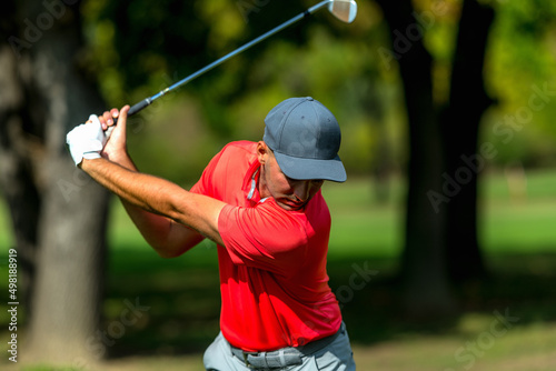 Powerful golf swing. Young golfing professional in golf swing