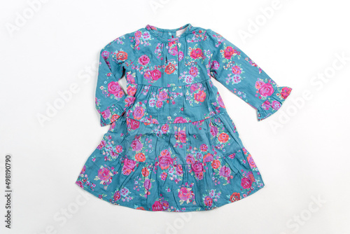 Elegant light children summer dresse. Blue dress with flowers, isolated