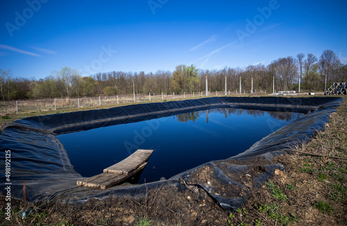 Insulated leachate pond with dirty water, part of landfill
