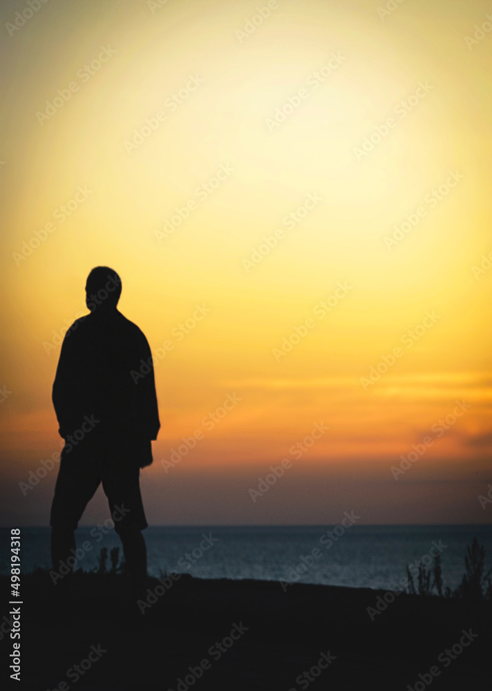 lone man silhouette on sea shore at sunset lone man silhouette on sea shore at sunset