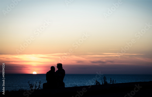 couple on sea shore at sunset