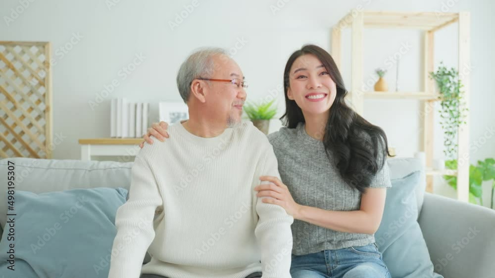 Portrait of Asian beautiful daughter hugging and sit with older father Portrait of Asian beautiful daughter hugging and sit with older father